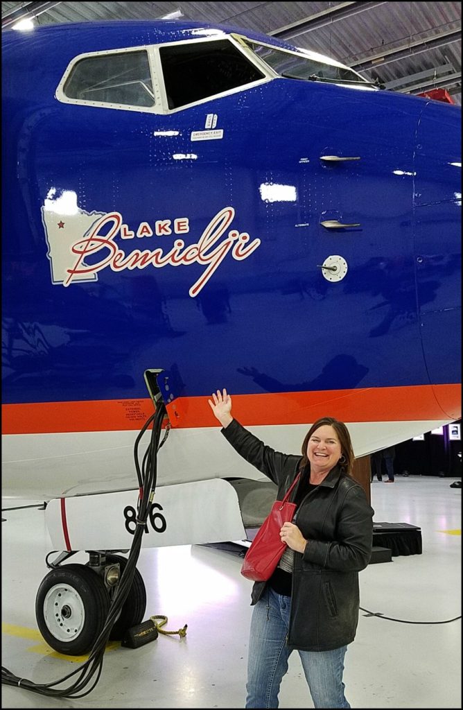 Sara with Sun Country plane