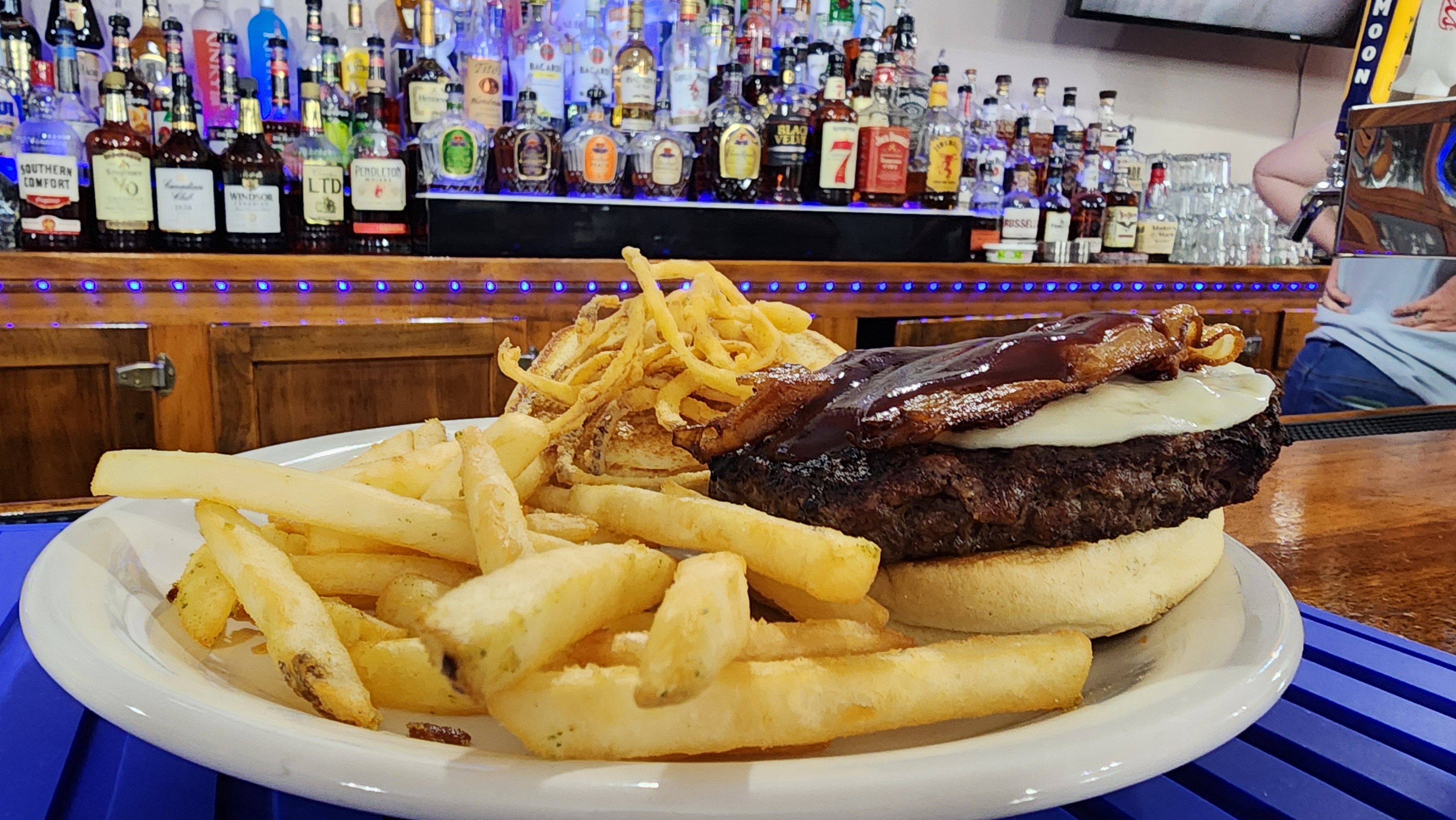 burger with bbq sauce and onion rings