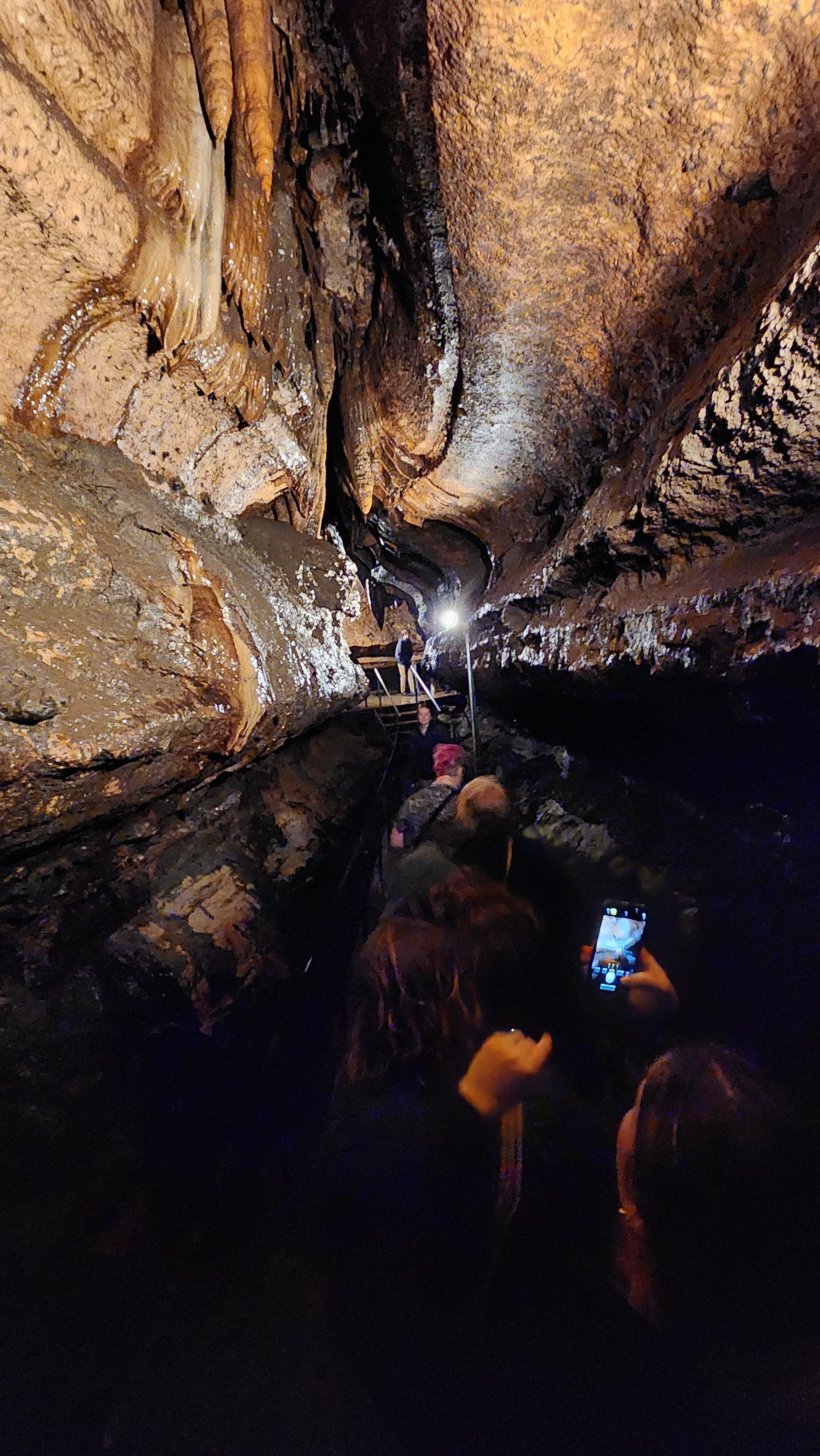 people in narrow cave