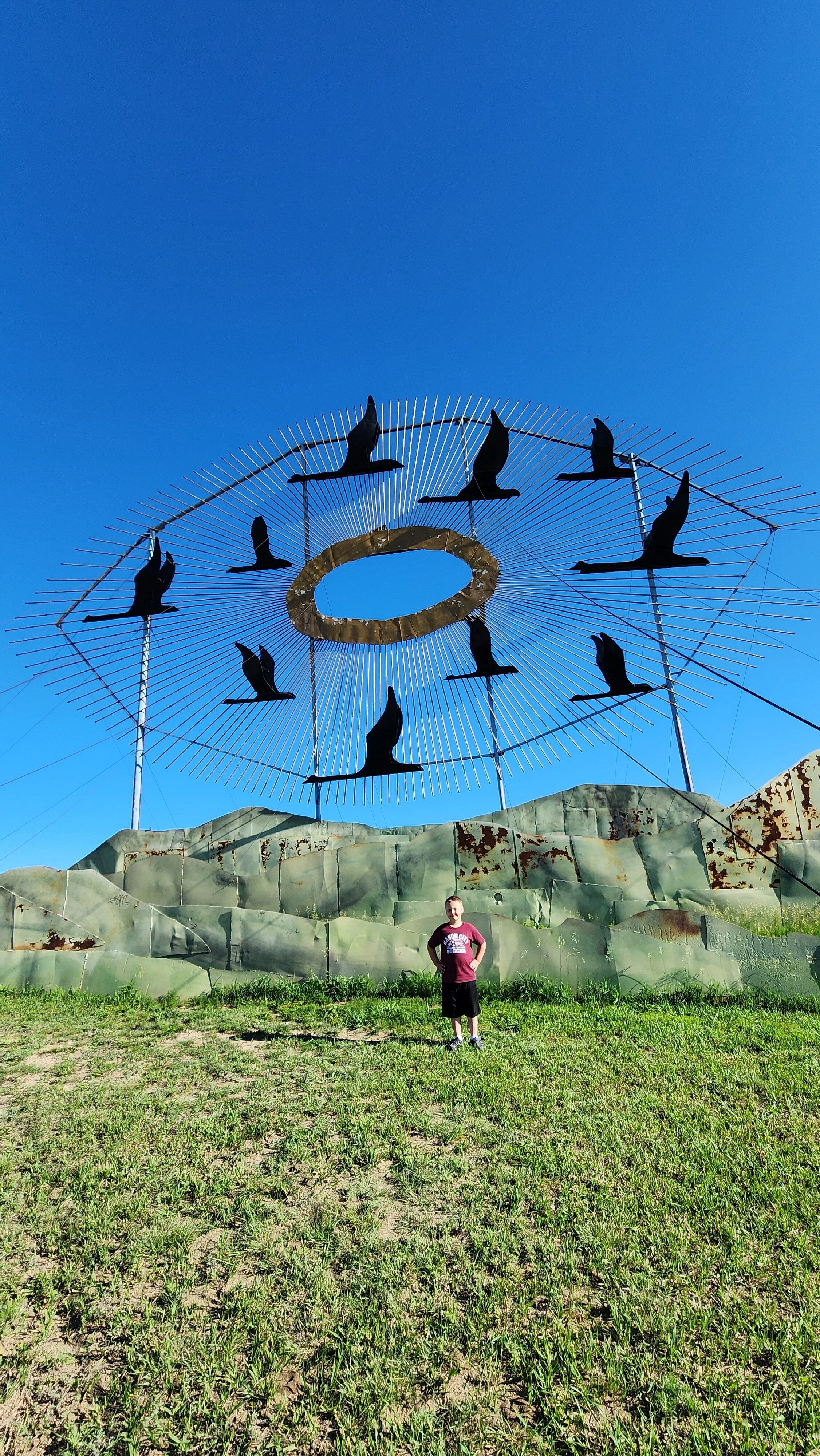 boy at metal sculpture