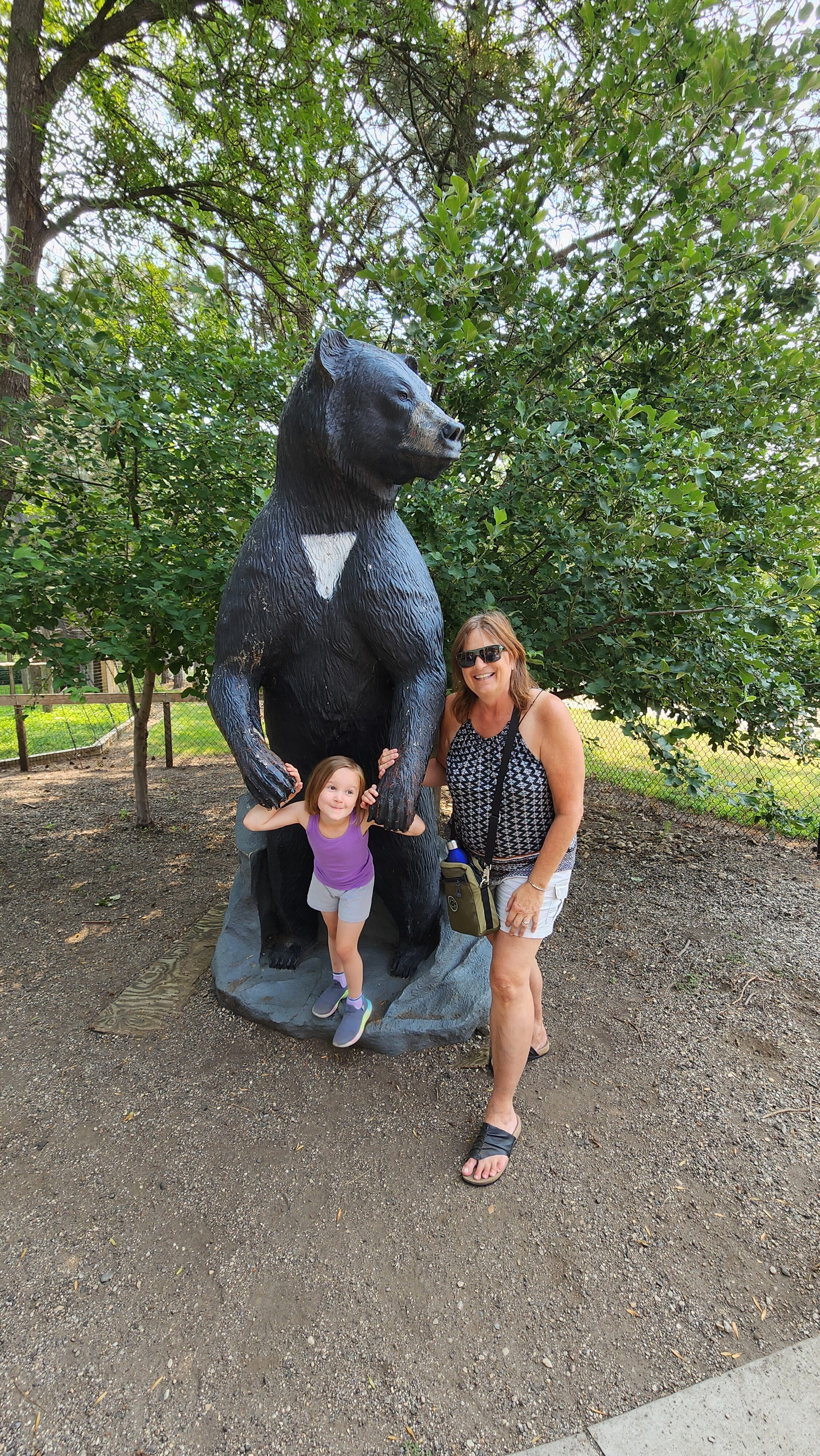 grandma granddaughter with bear statue