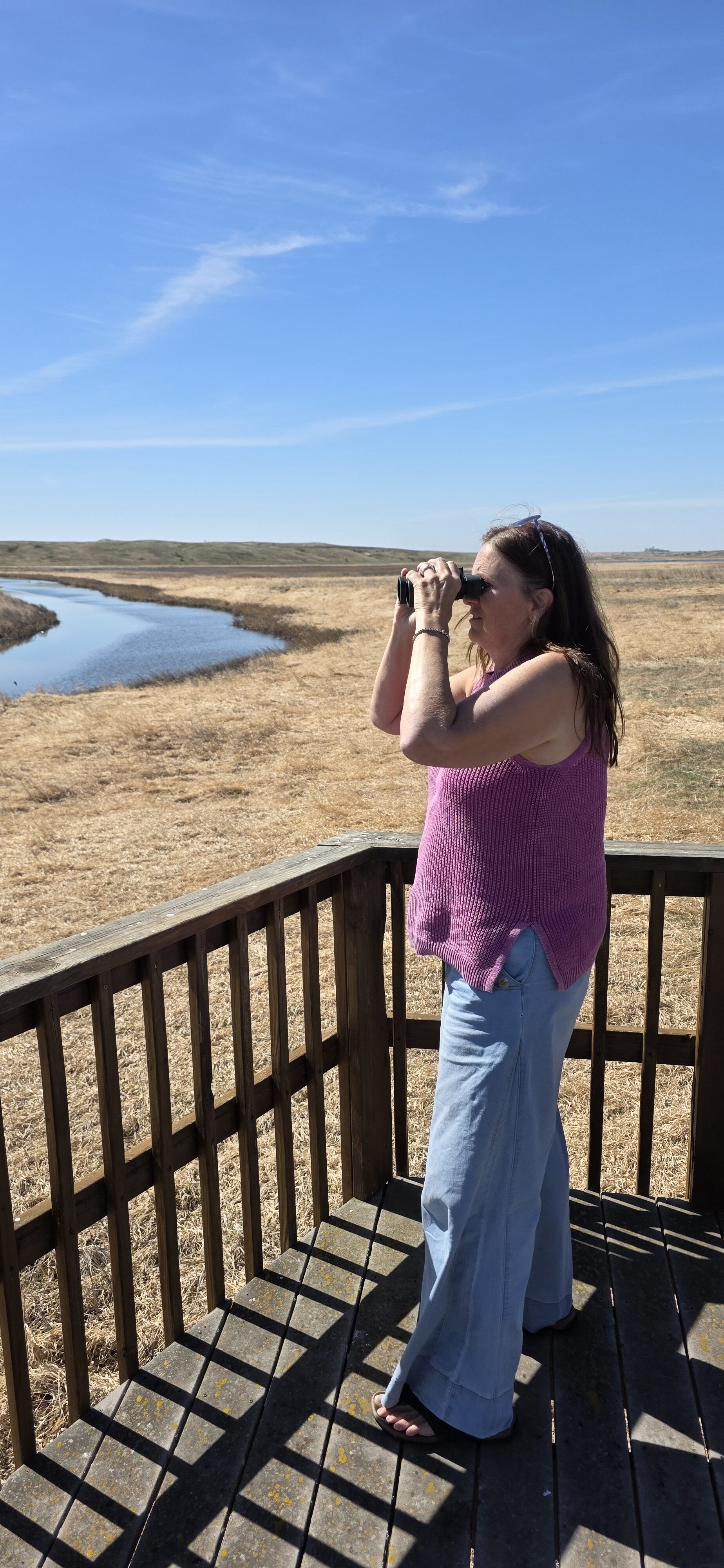 Lady with binoculars nature center Jamestown, ND