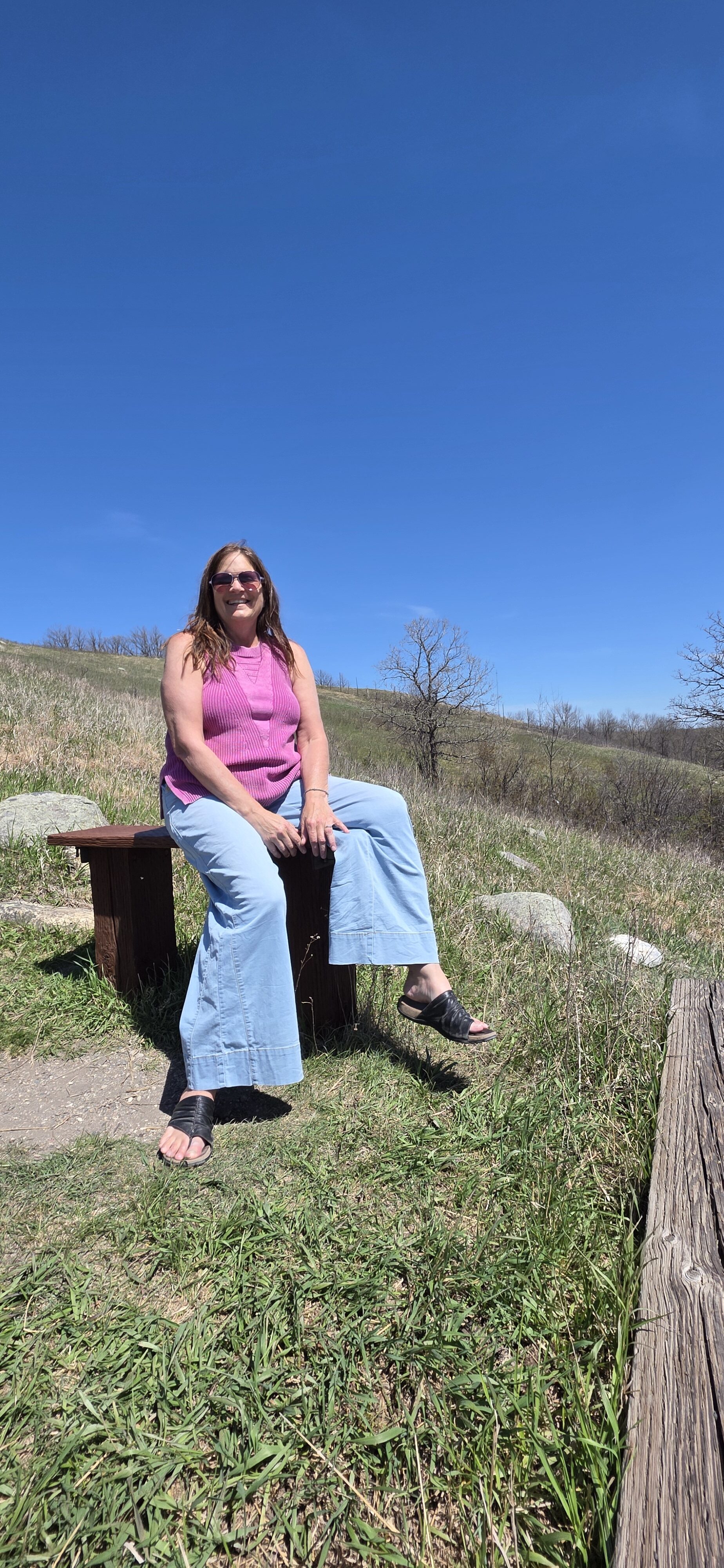 Sara of Travel With Sara on the stairs at White Horse Hill National Game Preserve in North Dakota