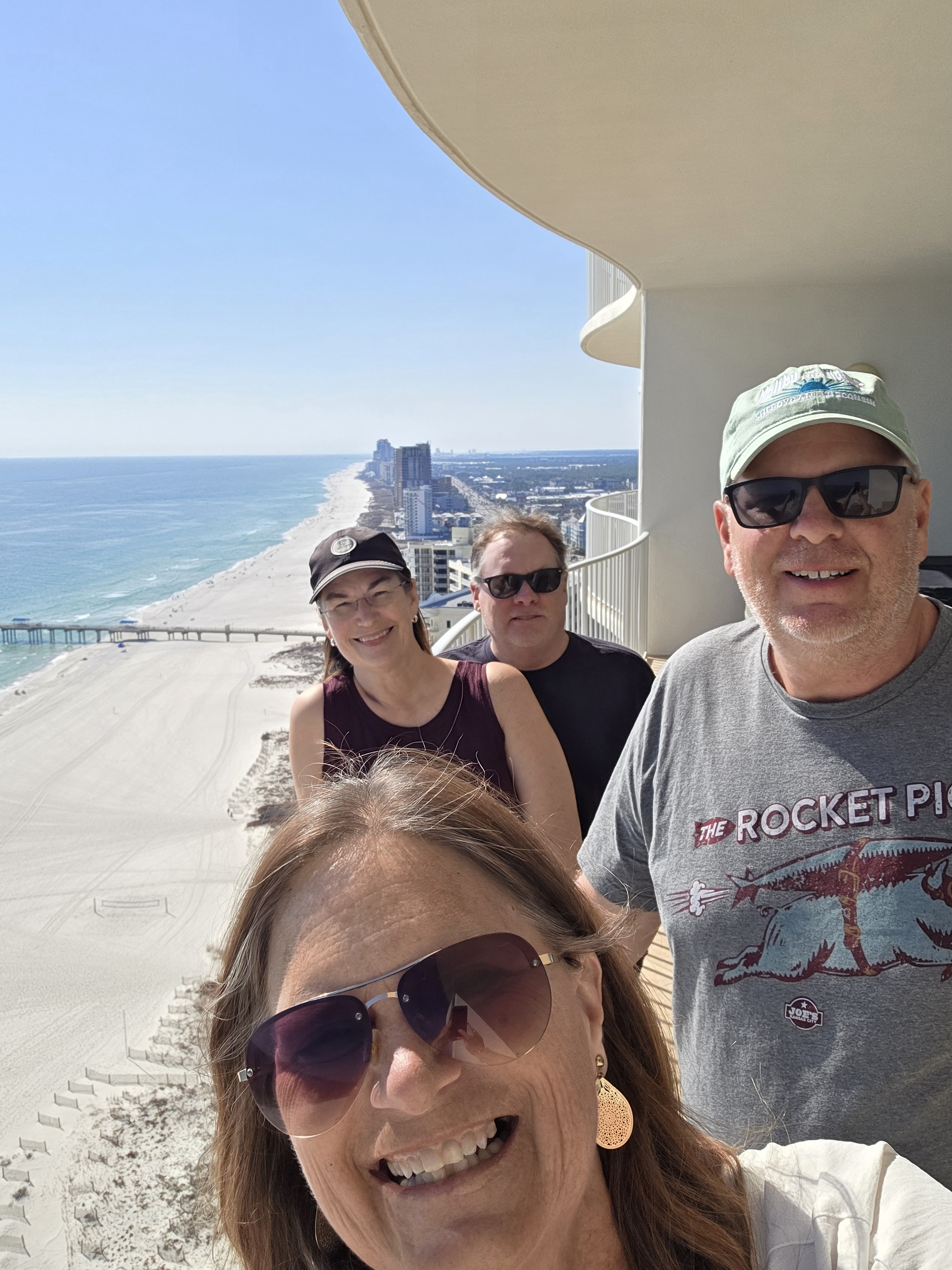Friends on balcony at Turquoise Place with Spectrum Resorts in Orange Beach, Alabama
